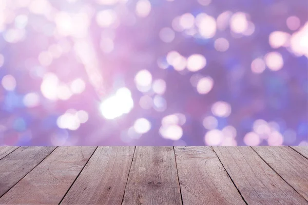 Old wooden table foreground with blurred blue bokeh background, empty space Place a product. Nature and health concept