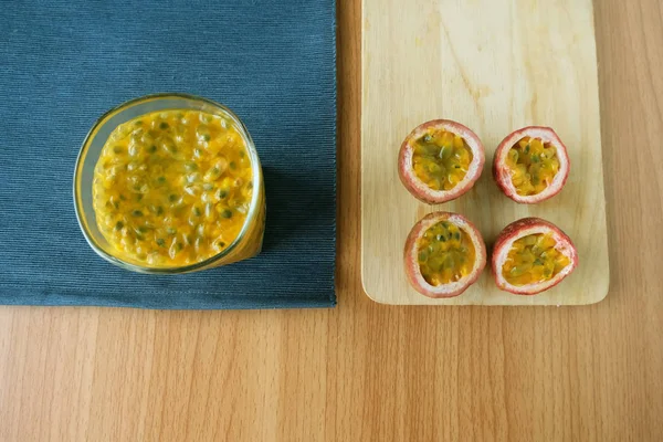 Passion fruit juice In the cup of glass on wooden background.Top view