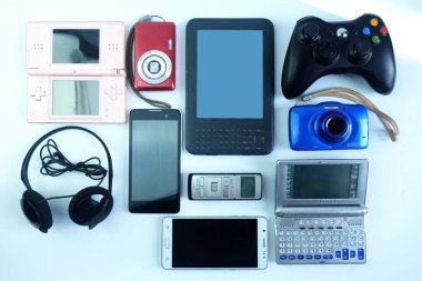 Zarar görmüş veya eski kullanılan elektronik gadget'lar beyaz arka planda, günlük kullanım için yeniden ve geri dönüşüm kavramı, üstten görünüm