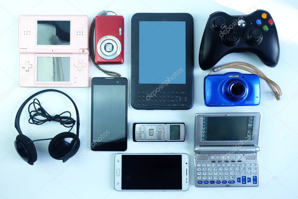 Damaged or old used electronics gadgets for daily use on white background, Reuse and Recycle concept, Top view