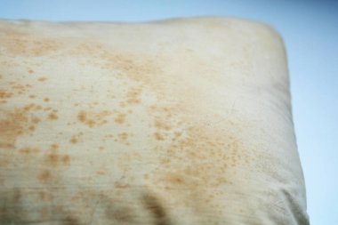 Close up Stains on dirty pillow are a source of germs and dust mites and mattresses, Selective Focus clipart