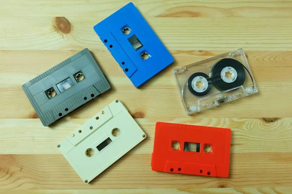 Colorful old cassette tape audio on wooden floors. Accessories for the 70-80-90\'s era