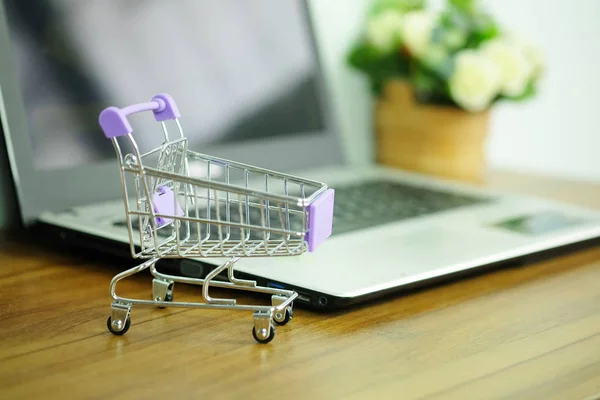 Shopping cart and laptop computer, Concepts online shopping where consumers can buy products directly from home or work.