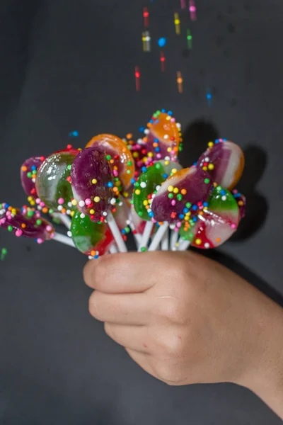 Bouquet Sweet Lollipops Held Young Hand — Stock Photo, Image