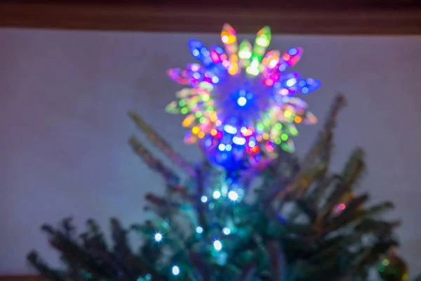 Defocused christmas tree lit up for the holidays — Stock Photo, Image