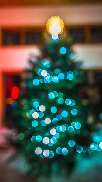 Defocused christmas tree lit up for the holidays — Stock Photo, Image