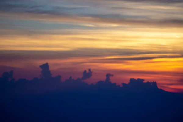 Sun setting over clouds views from airplane — Stock Photo, Image