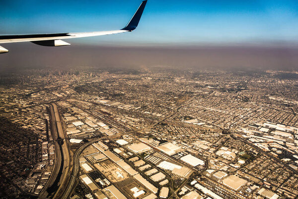 downtown los angeles skyline and suburbs from airplane and smoke