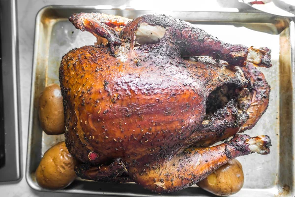 Smoked whole turkey and potatoes on a tray ready for lunch and d — Stock Photo, Image