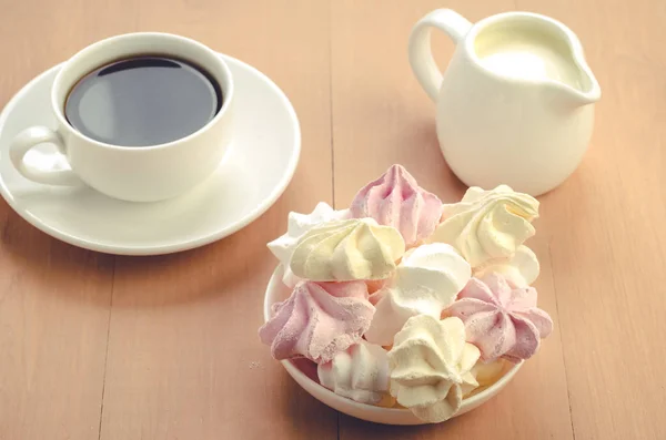 meringue, cup with coffee and creamer/meringue, cup with coffee and creamer. Top view