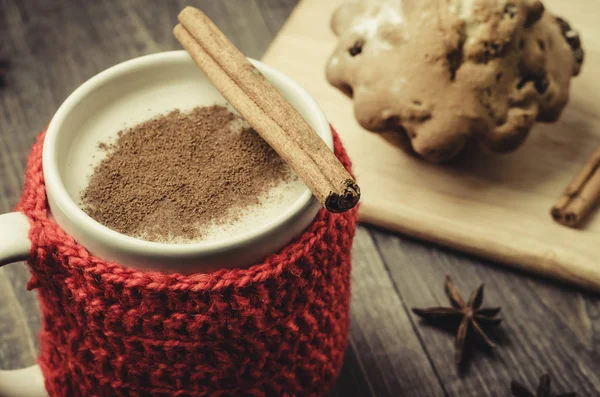 mug with eggnog with cinnamon and cake/mug with eggnog with cinnamon and cake on a wooden dark background. Top view