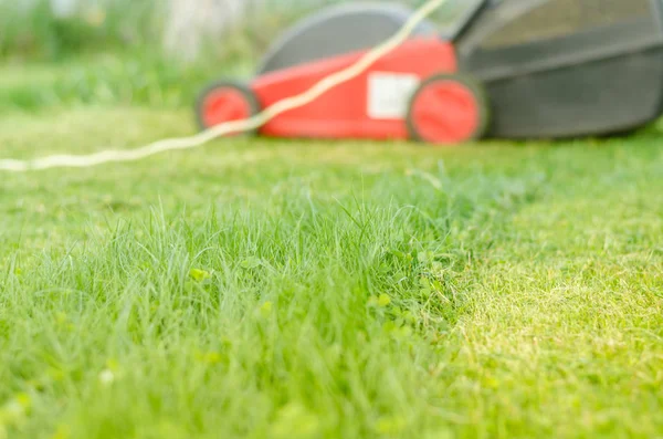 lawn mower is cleaned from a grass/lawn mower is cleaned from a grass. Selective focus