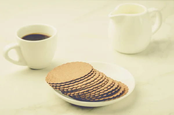 espresso white cup with cookies and milk/espresso white cup with cookies and milk on white table.