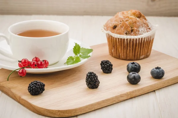 healthy breakfast: tea with mint, cake and fresh berries/healthy breakfast: tea with mint,  cake and fresh berries on a wooden surface. Selective focus