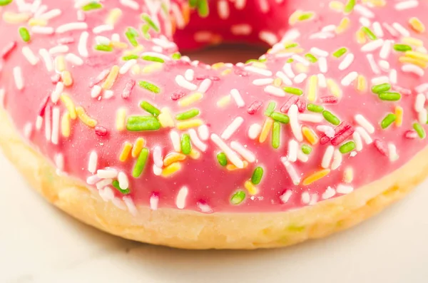 Sweet and colourful pink doughnut/Sweet and colourful pink doughnut on a background. Close up
