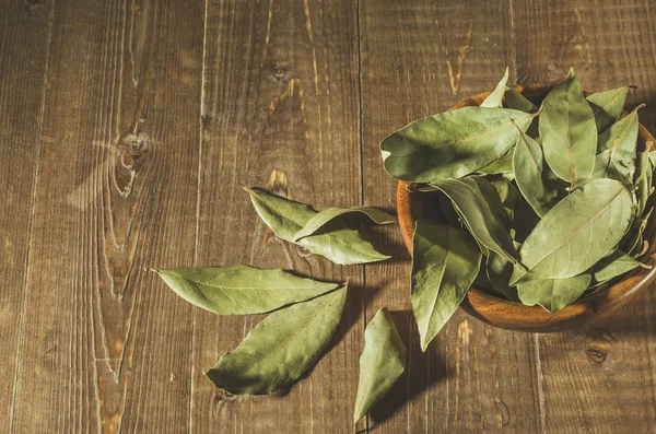 spices of bay leaf in rural style/spices of bay leaf in rural style on a wooden background. Top view