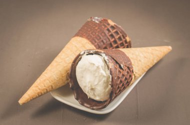 iki dondurma koni karanlık bir arka plan üzerinde çikolata ile / iki dondurma koni içinde çikolata, seçici odak ile