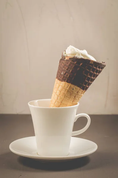 ice cream on a in a white cup/ice cream with cone in chocolate on a in a white cup, selective focus