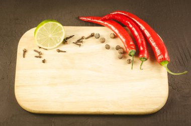 Baharatlar ve boş kesme kurulu/baharat ve boş kesme tahtası koyu arka plan üzerinde. Üstten görünüm. Kopya alanı