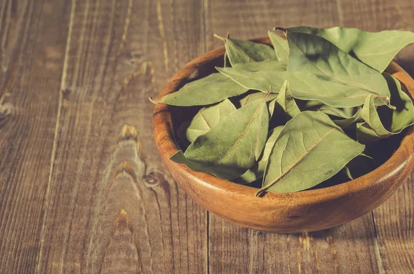 bay leaf in a wooden bowl/bay leaf in a wooden bowl on a wooden background. selective focu