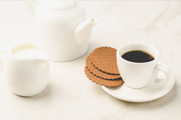 Coffe white cup with cookies and milk/Coffe white cup with cookies and milk on white marble background