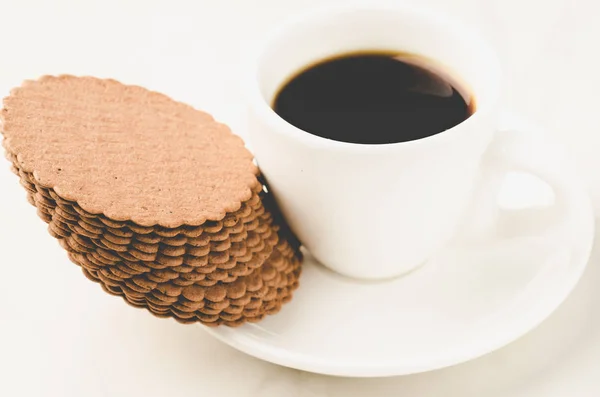 Coffe white cup with cookies/Coffe white cup with cookies. Selective focus