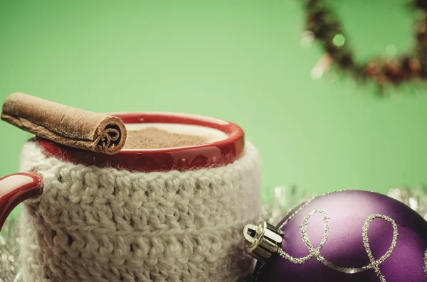 mug eggnog and Christmas decoration on a green background/mug eggnog and Christmas decoration on a green background. Selective focus