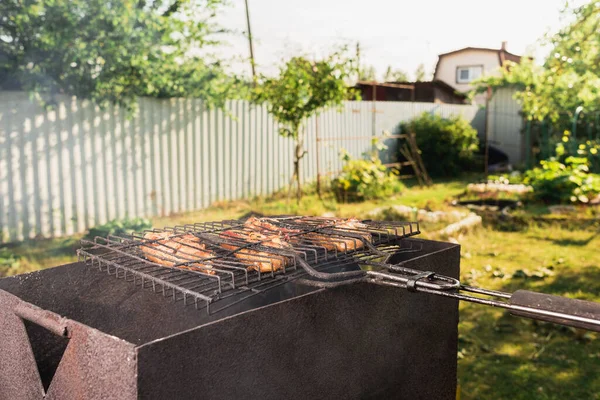 outdoor grilled chicken barbecue/barbecue chicken on the grill outdoors on a sunny da