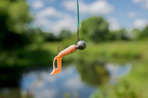 silicone fishing bait/silicone fishing bait on the background of the river