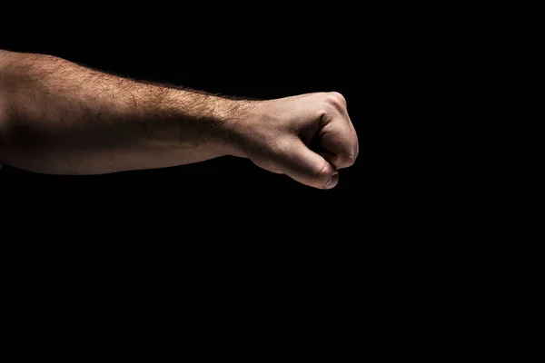 strong male man raised fist on a black background, power, protest, fist ready to fight