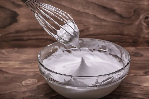 Whipped egg whites for cream on wooden table, top view — Stock Photo, Image