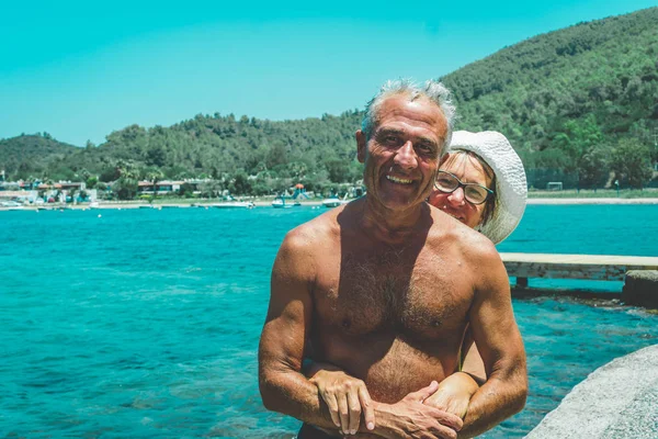 Happy senior couple by the sea enjoying retirement. Stock Picture