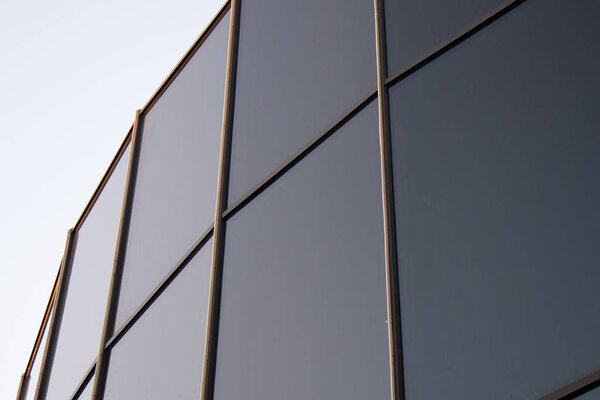Glass architecture. Double-exposure tilt photo of contemporary office building facade