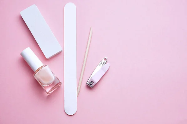 Manicure tools on pink background