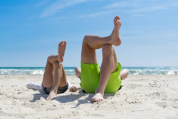 Father and son having fun on the beach, laying on a beach — Stock Photo, Image