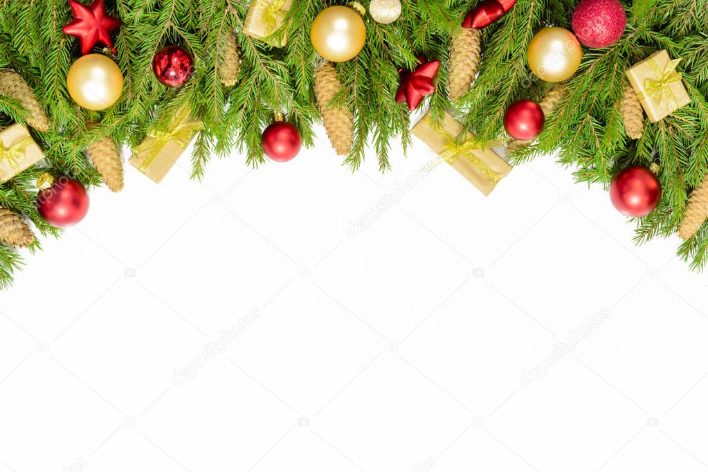Wide arch shaped Christmas border isolated on white, composed of fresh fir branches and ornaments in red and gold
