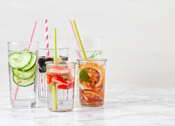 Herbs and fruits flavored infused water. Summer refreshing drink. Health care, fitness, healthy nutrition diet concept.