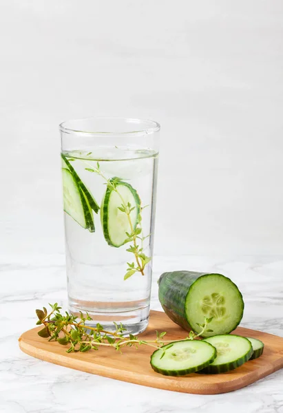 Cucumber and thyme flavored infused water. Summer refreshing drink. Health care, fitness, healthy nutrition diet concept.