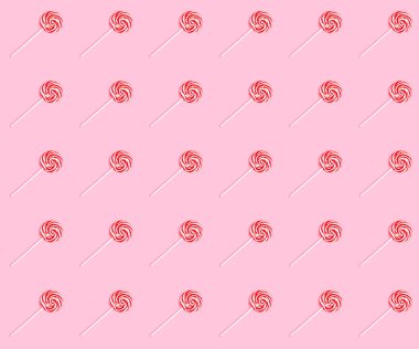 Pembe bir arka plan üzerinde çizgili tatlı lolipop ile sorunsuz partern