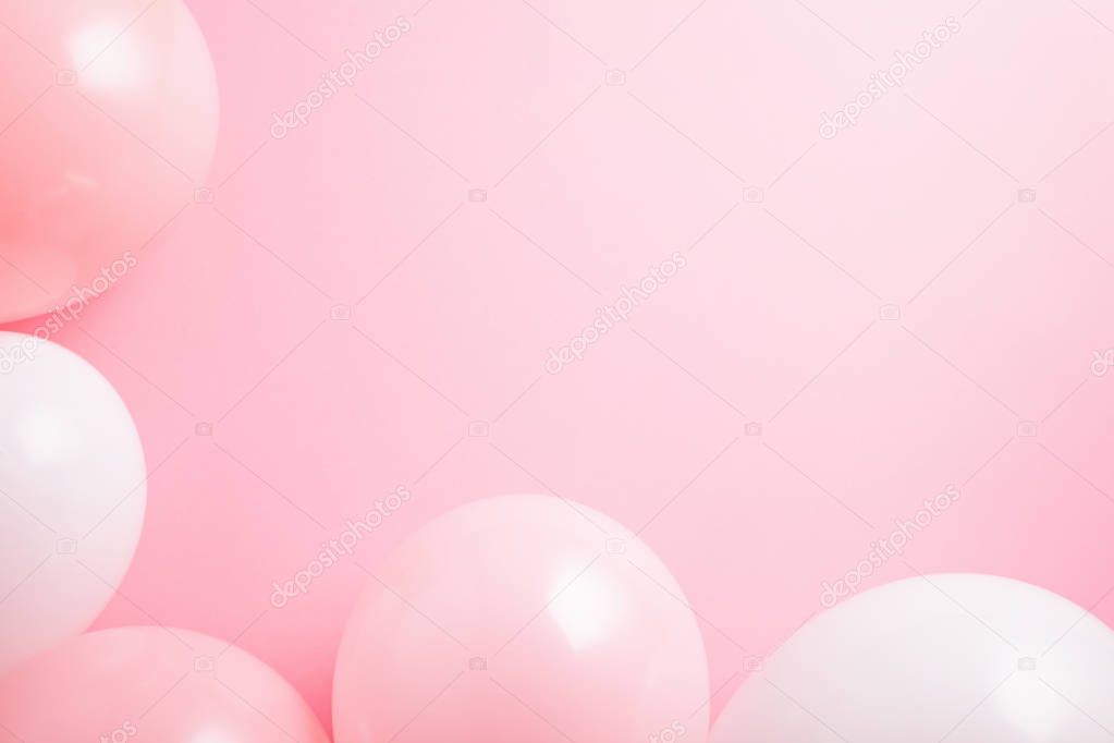 Top view shot with pink and white balloons over the pink background. Celebration and greetings concept