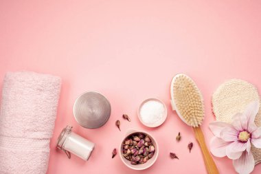 Feminine beauty and spa products, tools and cosmetics over the millennial pink background clipart