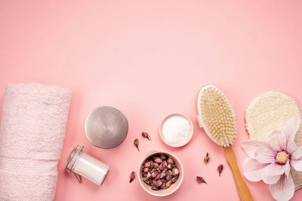 Feminine beauty and spa products, tools and cosmetics over the millennial pink background