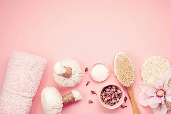 Feminine beauty and spa products, tools and cosmetics on pink background