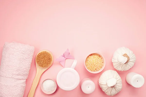 Feminine beauty and spa products, tools and cosmetics on pink background