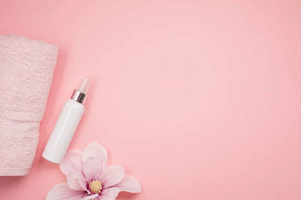 Feminine beauty and spa products, tools and cosmetics on pink background