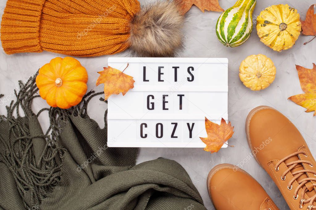 Flat lay with comfort warm outfit for cold weather. Lightbox with the text It's Sweater Weather. Comfortable autumn, winter clothes shopping, sale, style in trendy colors concept