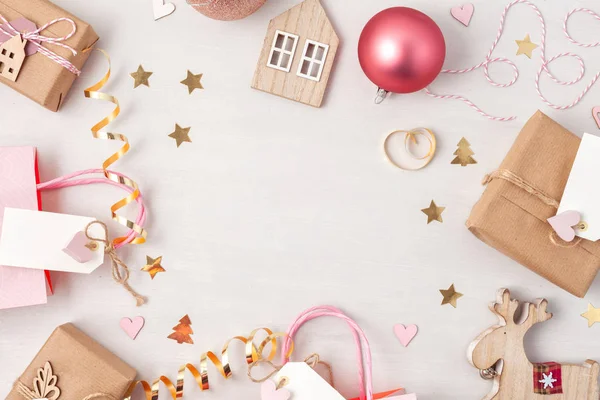 Flat lay of morden minimalist Christmas gifts and wooden christmas decoration in pastel colors