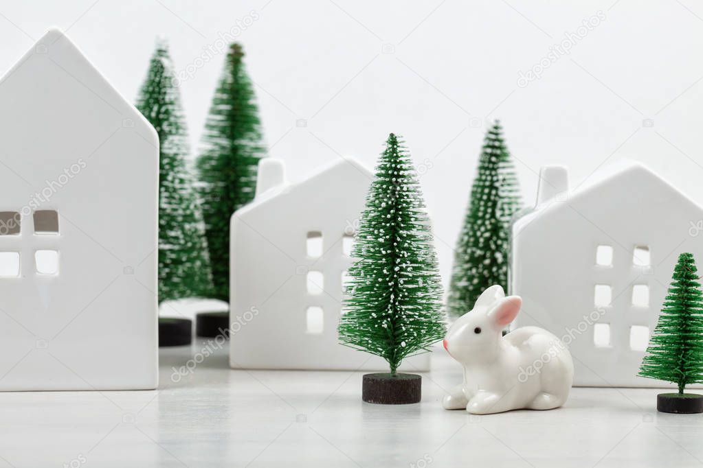 Cute little white houses and christmas trees with the copy space for text. Christmas celebration idea