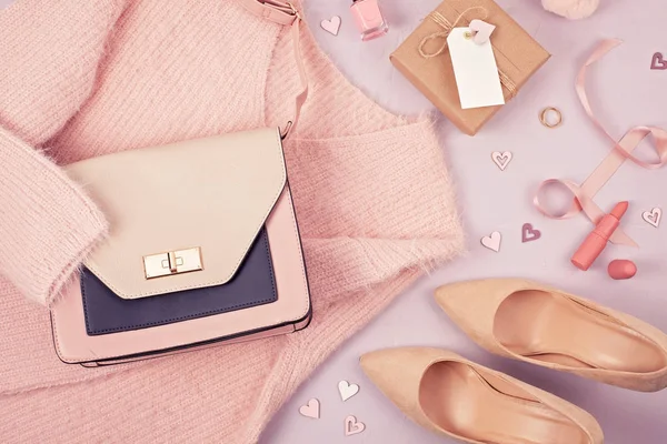 Flat lay of woman clothing and accessories in pastel colors. Modern classic style concept
