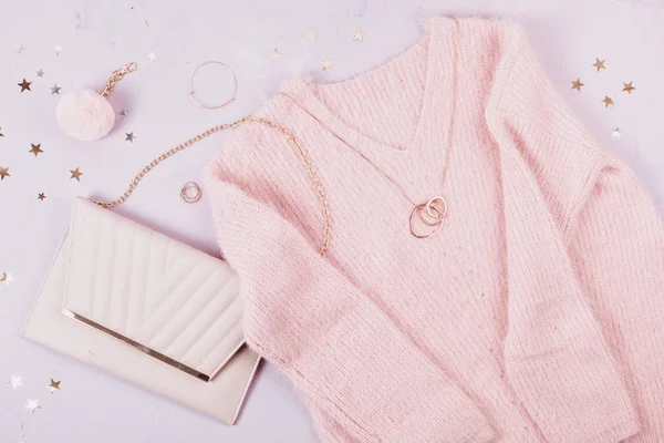 Flat lay of woman clothing and accessories in pastel colors. Modern classic style concept